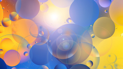 bright oily drops in water with colorful background, close-up
