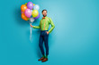 © deagreez - Full length body size view of nice attractive confident cheerful guy holding in hands carrying delivering air balls isolated on bright vivid shine vibrant blue green teal turquoise color background