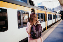 Happy Young Woman Walking At Train Station. Travel Concept