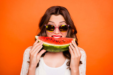 Wall Mural - Portrait of cheerful positive cute nice cool youngster biting a wedge of watermelon wearing eyeglasses spectacles eyewear isolated vivid color background