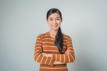 Young asian woman portrait smiling with crossed arms, happy feeling in brown sweater.