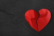 Torn Paper Heart On Black Stone Background, Top View With Space For Text. Relationship Problems Concept