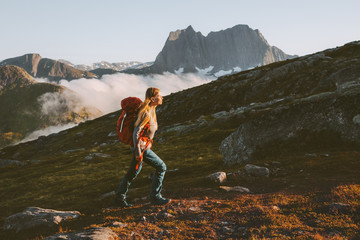 woman traveler hiking in mountains with backpack adventure travel active healthy lifestyle summer va