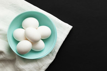 Traditional Easter Food Eggs. Colored Dishes On A White Napkin And Black Background. Minimalistic Design. Copy Space. Colors Trend 2020