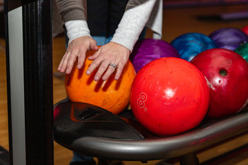  Bowler drying hands in front of bowling balls