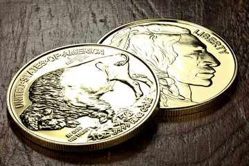 1 ounce American Buffalo gold bullion coins on wooden background