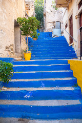 Wall Mural - Charming alley with blue painted steps in old town on the Greek island of Symi, Greece