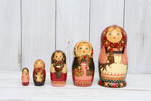 Russian National Wooden Nesting Toys - Matryoshka (nested Doll) - In Form Of Women In National Costume With Shawl And Children. Photo On White. Russian Style In Folk Art, Ethnic Handicraft. Souvenir