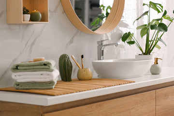 Stylish vessel sink on light countertop in modern bathroom