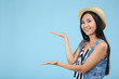 © 5second - Beautiful young woman in straw hat on blue background