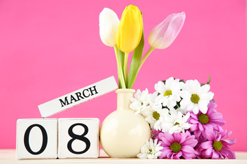 Wall Mural - Cube calendar with tulip and chrysanthemum flowers on pink background