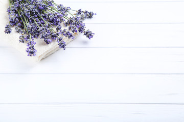 Wall Mural - Lavender flowers with towel on white wooden table