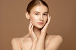 © Beauty Agent Studio - Beauty treatment portrait. Beautiful young woman with perfect skin posing against beige background.