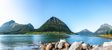 Panoramic View From Luroy At Ford With Aldra Island (left), Olvika (center) And Some Unknown High Mountain (left). The Wall Of Heavy Stones On Sandy Beach Close Photographer, Tide Time, Sunny Norway