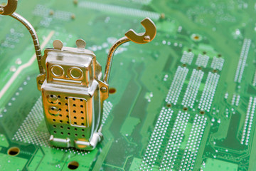 Search engine robot is looking for the best online website metaphor with toy robot on computer curuit board