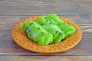 Wall Mural - Thai dessert : Thai coconut crepes (Tong Muan Sod), traditional Thai dessert made from rice flour, fresh young coconut meat, coconut milk and black sesames. Selective focus.