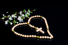 Rosary Beads And Prayer Book. Rosary On Black  Background. White  Spring Flowers