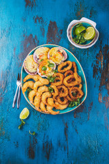 SEAFOOD hot platter baked scallops, fried squid rings and shimps