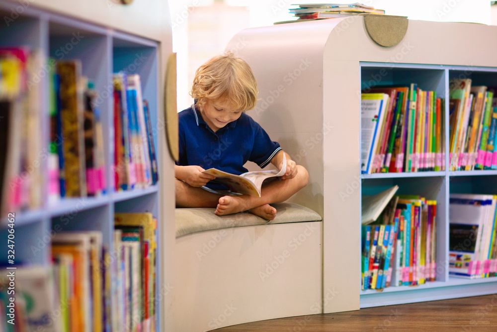 Child in school library. Kids reading books. Stock Photo | Adobe Stock