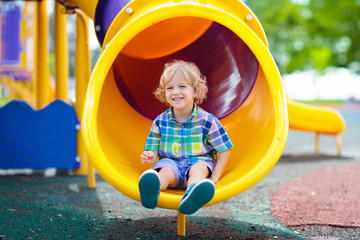 Child on playground. Kids play outdoor.