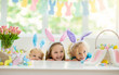 © famveldman - Kids on Easter egg hunt. Children dye eggs.