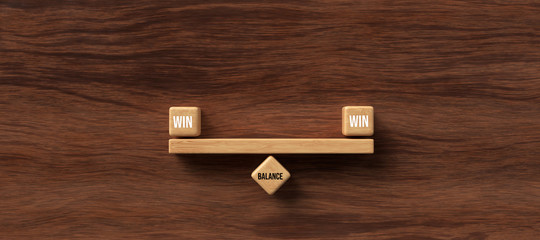 Wall Mural - wooden blocks formed as a seesaw with the words WIN, WIN and BALANCE on wooden background
