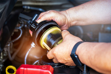 Car mechanic check the fuel filter at diesel engine. service or Preventive maintenance..