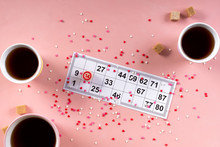 Lotto Ticket With Wood Barrel 14 Number And Coffee Tea Cups, Sweets Candy Chocolate On Pink Hearts Background. Valentines Day 14 February Minimal Concept
