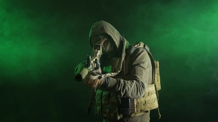 Wall Mural - soldier-saboteur in military clothing with weapons on a dark background