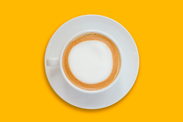 Wall Mural - latte coffee in a ceramic coffee cup isolated on bright yellow background top view