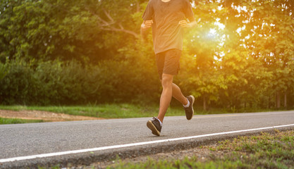 Wall Mural -  Young black runner man running on the street be exercise and workout in nature countryside road in the morning. Healthy body exercise sports concept.