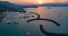 Sunset Panoramic Marina Town Aerial. Airlie Beach Waterfront Aerial View. Dramatic DRONE View From Above. Marina Town With Yachts And Boats In Sea Water. Mountain Landscape. Whitsundays Islands