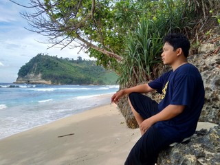 Young man on the beautiful beach