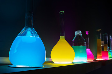 Laboratory glass chemical containers. Colorful illuminated test tubes.