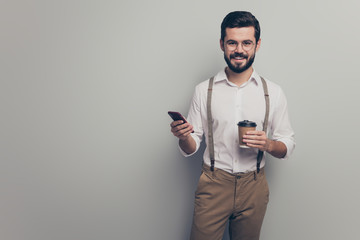 Sticker - Positive cool attorney man student hold take-out mug beverage latte use smartphone follow social network news wear formalwear white shirt brown pants trousers isolated grey color background