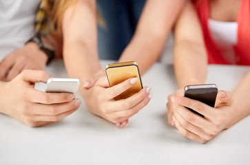 technology and people concept - close up of hands with smartphones