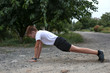 © Oksana - Teenager in white t-shirt doing plank outdoors. Yoga pose