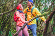 © DisobeyArt - Young couple walking inside rainy forest - Explorers people having fun into the woods - Travel, discovery, trekking, vacation and nature concept - Main focus on man face