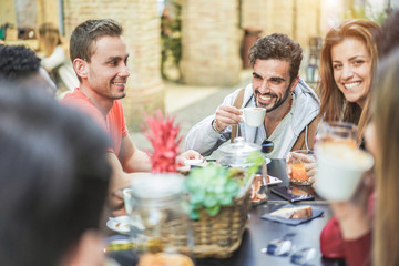 Wall Mural - Group of happy friends drinking coffee and cappuccino at vintage bar outdoor - Young millennials people doing breakfast together - Friendship, youth and food concept - Focus on right man face