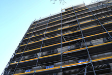 Yellow Scaffolding Of A Bulding Under Restoration On A Clear Sunny Day