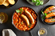 Sausages with baked white beans in tomato sauce