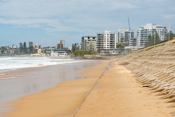 Beatiful empty urban beach in Sydney, Australia. Concrete basement exposed at North Cronulla after the storm which sucked thousand of tonnes of sand into the ocean