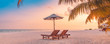Leinwandbild Motiv Best beach sunset panorama. Tropical landscape scene. Amazing sunset sea view with palm leaves and two lounge chairs with umbrella. Luxury lifestyle, travel and summer vacation background
