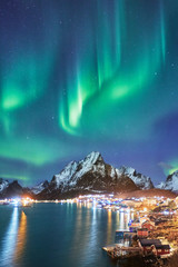 northern lights over olstinden in lofoten islands and reine