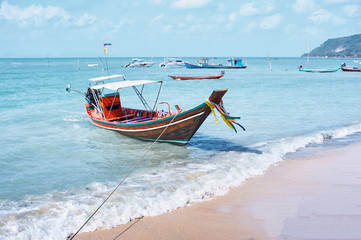 Travel by Thailand. Landscape with traditional longtail fishing boat on the sea beach.