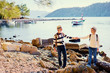 © luengo_ua - Travel and tourism. Senior family couple walking together on Mediterranean sea beach.