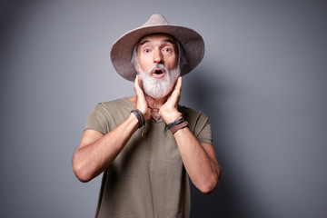 Canvas Print - Shock and surprise! Studio portrait of amazed senior man with gray beard and hat.