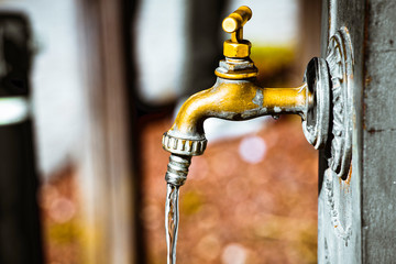 Beautiful brass faucet inside the wall.