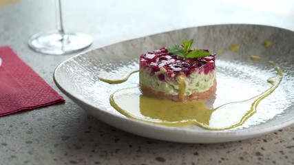 Wall Mural - Salmon tartare on plate in restaurant.