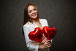 © DSMT - Beautiful girl in a white jacket with a red balloon heart in her hands